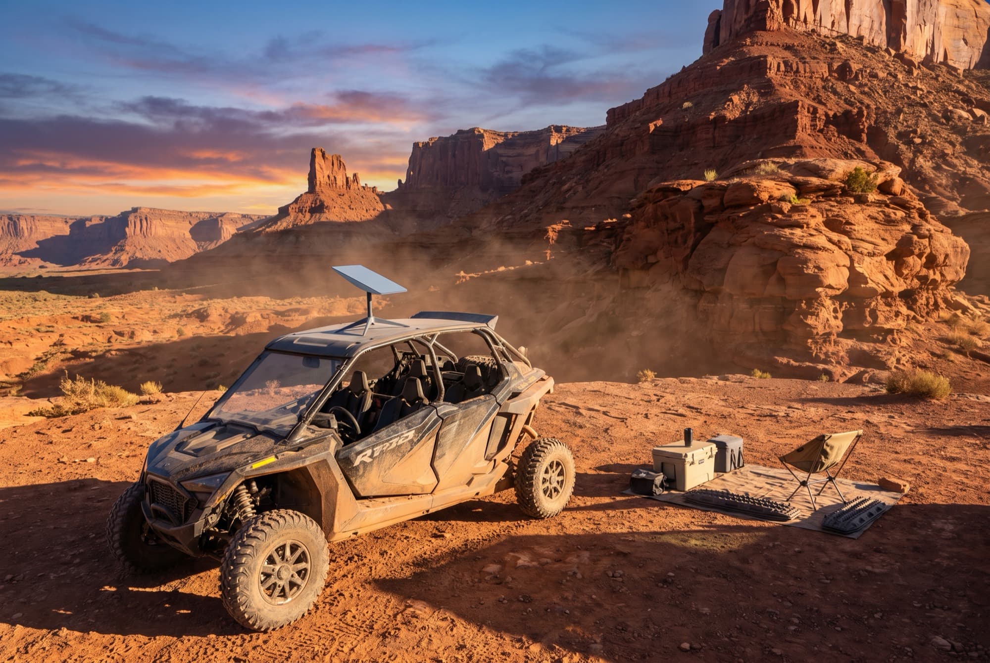 Starlink dish at an overland basecamp beside a UTV